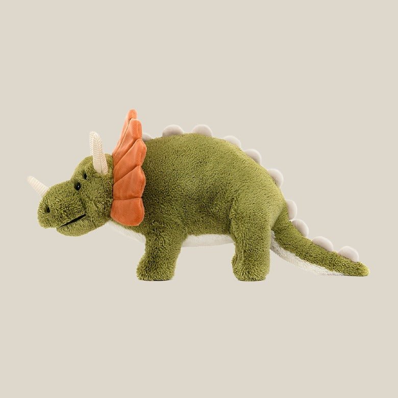 Archie Dinosaur - CanoayrasJellycat - A smiling green triceratops stuffed animal with a orange frill, turned to the side